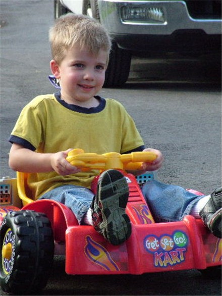 Matt driving a toy car