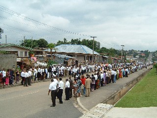 People waiting on the street outside the temple